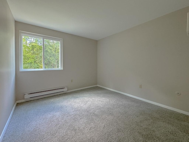 spare room featuring baseboards, a baseboard heating unit, and carpet flooring