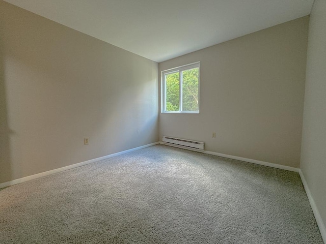 carpeted spare room featuring a baseboard radiator and baseboards
