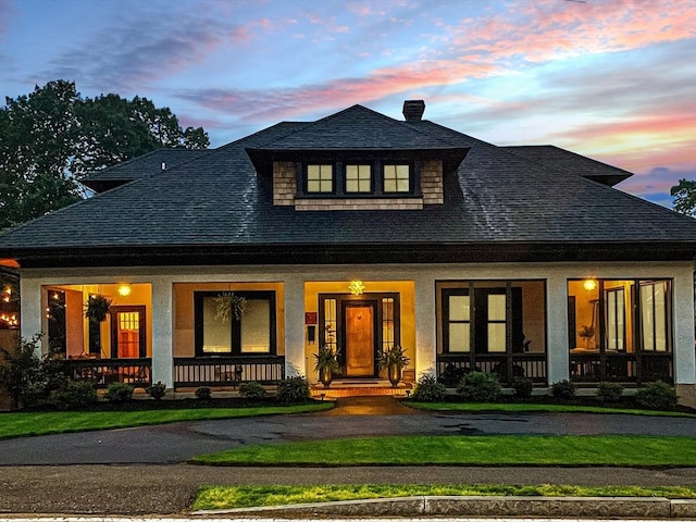 332 Eliot St, Milton, MA 02186 - view of front of home featuring covered porch, a shingled roof, a chimney, and a front lawn