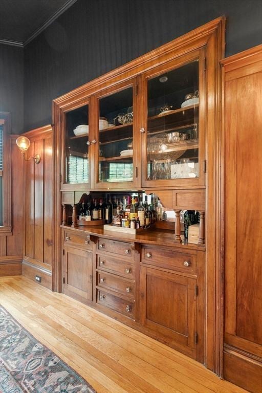 332 Eliot St, Milton, MA 02186 - indoor dry bar featuring ornamental molding and wood finished floors