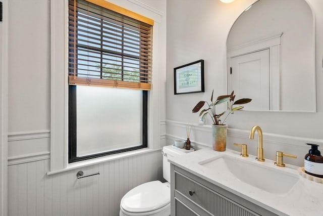 332 Eliot St, Milton, MA 02186 - bathroom featuring a wainscoted wall, vanity, and a decorative wall