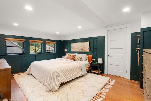 332 Eliot St, Milton, MA 02186 - bedroom with a decorative wall, wood finished floors, recessed lighting, and lofted ceiling