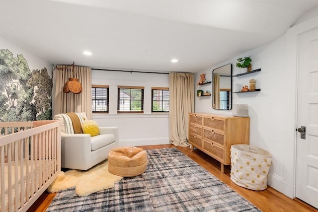 332 Eliot St, Milton, MA 02186 - bedroom with wood finished floors, recessed lighting, and a crib