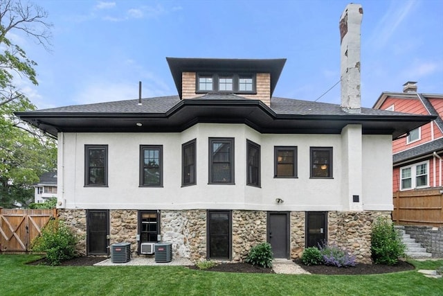 332 Eliot St, Milton, MA 02186 - rear view of property featuring stone siding, stucco siding, and roof with shingles