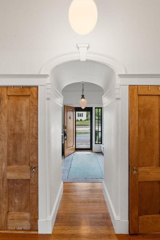 332 Eliot St, Milton, MA 02186 - hall with arched walkways and wood finished floors