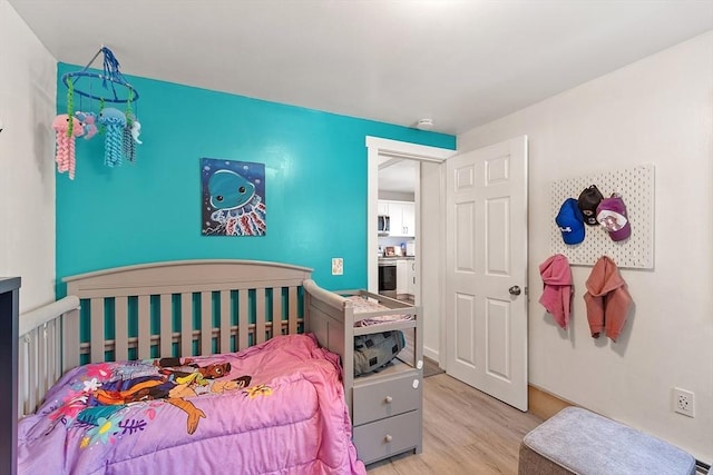 bedroom featuring light wood-style floors
