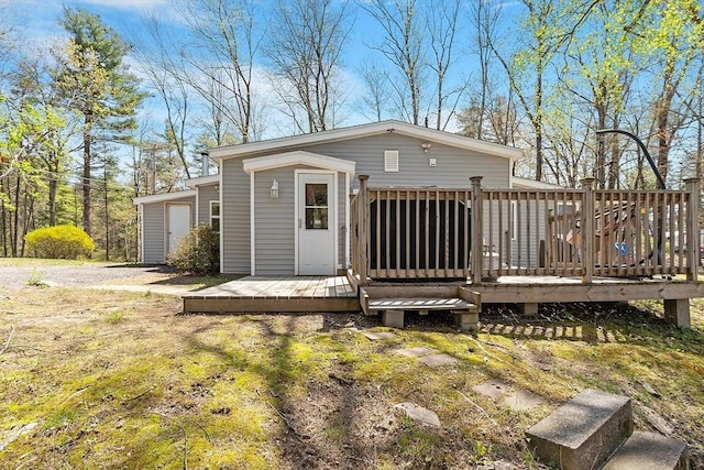 back of property with a wooden deck