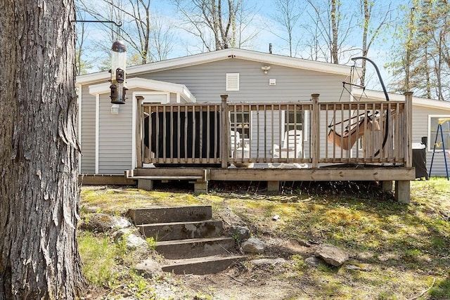 back of house with a wooden deck