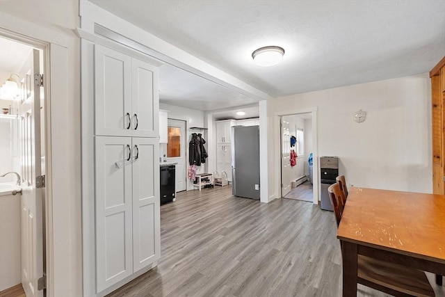 office featuring baseboard heating and light wood-type flooring