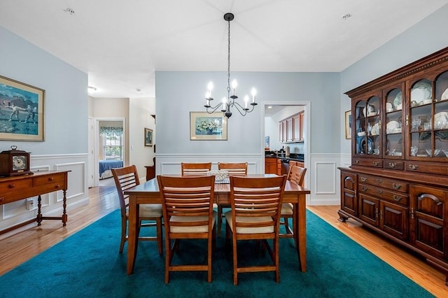 17 Cortland Grove Dr Unit 17, Shrewsbury, MA 01545 - dining space featuring wood finished floors, a chandelier, wainscoting, and a decorative wall