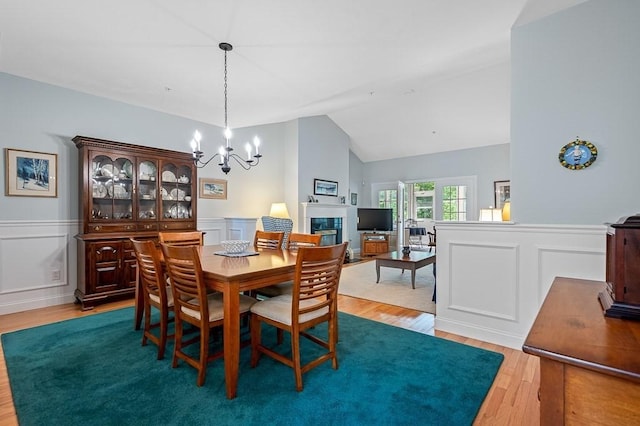 17 Cortland Grove Dr Unit 17, Shrewsbury, MA 01545 - dining space featuring light wood finished floors, a chandelier, a wainscoted wall, vaulted ceiling, and a decorative wall