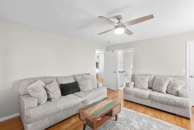 living room with ceiling fan, wood finished floors, and baseboards