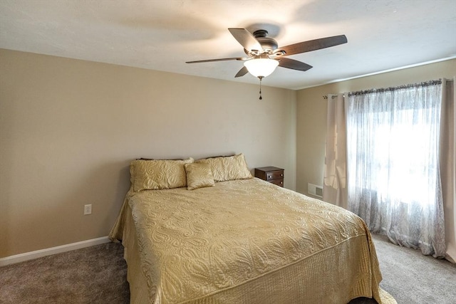 carpeted bedroom with baseboards, visible vents, and a ceiling fan