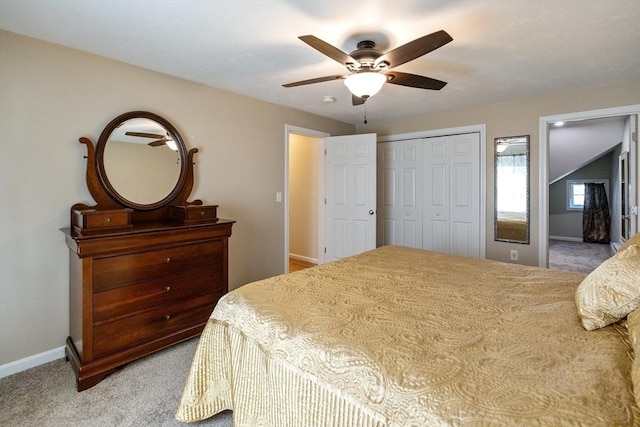 carpeted bedroom with a closet, a ceiling fan, and baseboards