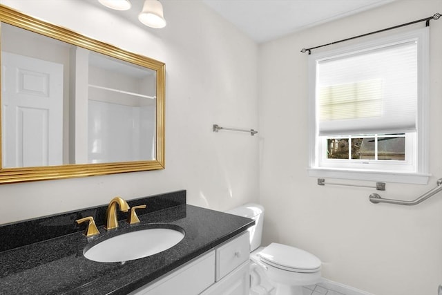 full bath featuring baseboards, vanity, and toilet