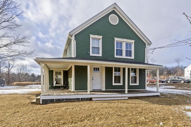 country-style home featuring a front yard and a porch