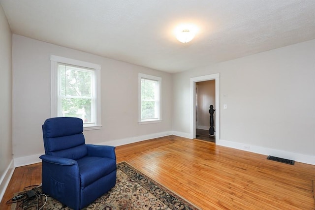 living area featuring wood finished floors and baseboards