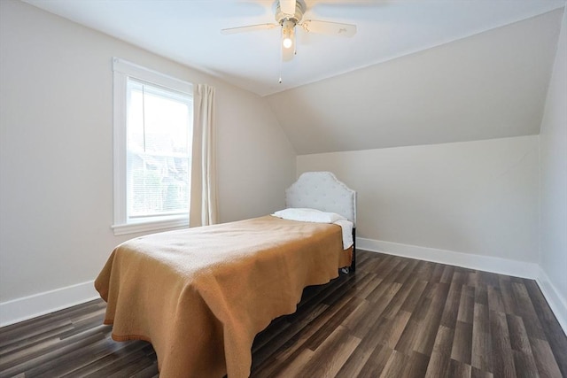 bedroom featuring baseboards, lofted ceiling, dark wood-style floors, and ceiling fan