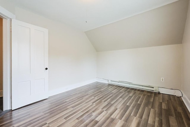 additional living space featuring a baseboard heating unit, wood finished floors, lofted ceiling, and baseboards