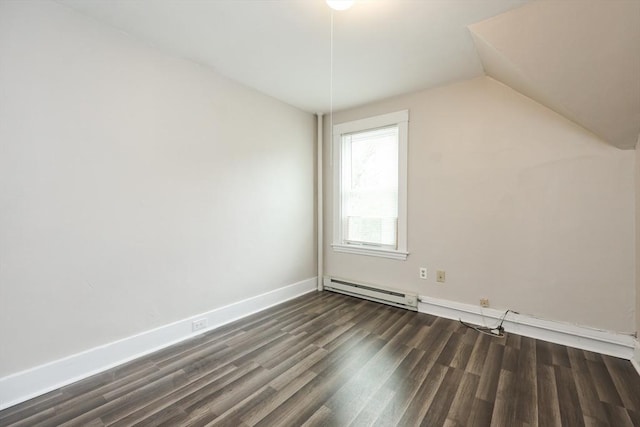 additional living space featuring dark wood finished floors, vaulted ceiling, a baseboard heating unit, and baseboards