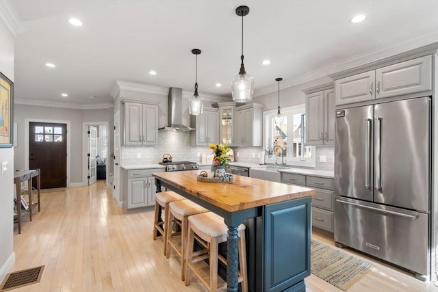 7 Bethpage Ln, Plymouth, MA 02360 - kitchen featuring stainless steel appliances, a sink, visible vents, wall chimney range hood, and butcher block counters