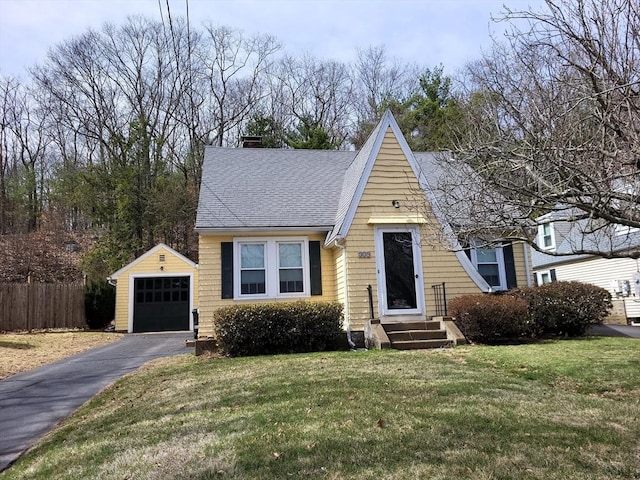 329 Worcester St, Southbridge, MA 01550 - a-frame style home with a garage, fence, driveway, roof with shingles, and an outbuilding