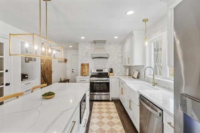 4 Barrows Brook Cir, Kingston, MA 02364 - kitchen featuring stainless steel appliances, premium range hood, a sink, white cabinetry, and decorative backsplash