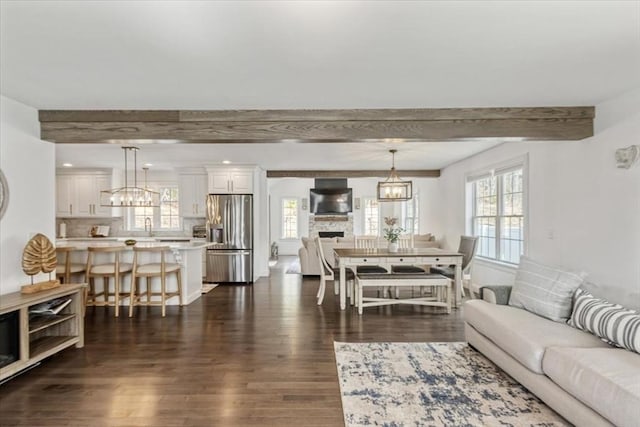 4 Barrows Brook Cir, Kingston, MA 02364 - living area with beamed ceiling, dark wood-type flooring, and a chandelier