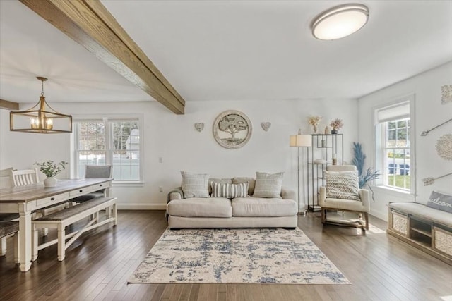 4 Barrows Brook Cir, Kingston, MA 02364 - living area featuring plenty of natural light, dark wood-style floors, beam ceiling, a chandelier, and baseboards