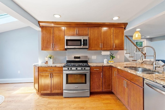 9 Crescent Ave, Lynnfield, MA 01940 - kitchen with appliances with stainless steel finishes, light wood finished floors, light stone countertops, brown cabinetry, and recessed lighting
