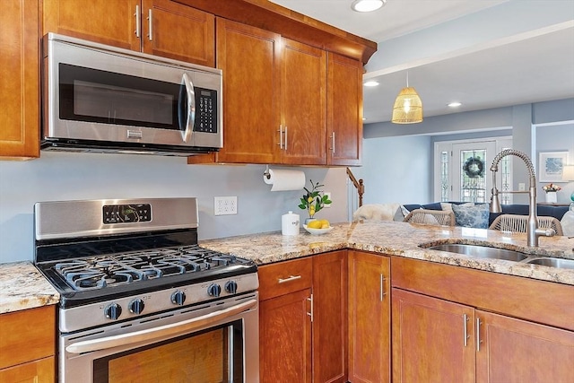 9 Crescent Ave, Lynnfield, MA 01940 - kitchen with appliances with stainless steel finishes, brown cabinetry, light stone countertops, and recessed lighting