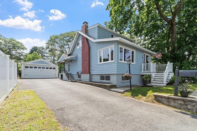 9 Crescent Ave, Lynnfield, MA 01940 - view of side of home with an outbuilding, a detached garage, a chimney, stairway, and a wooden deck