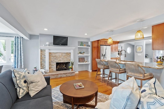9 Crescent Ave, Lynnfield, MA 01940 - living room with light wood-style flooring, a fireplace, and recessed lighting
