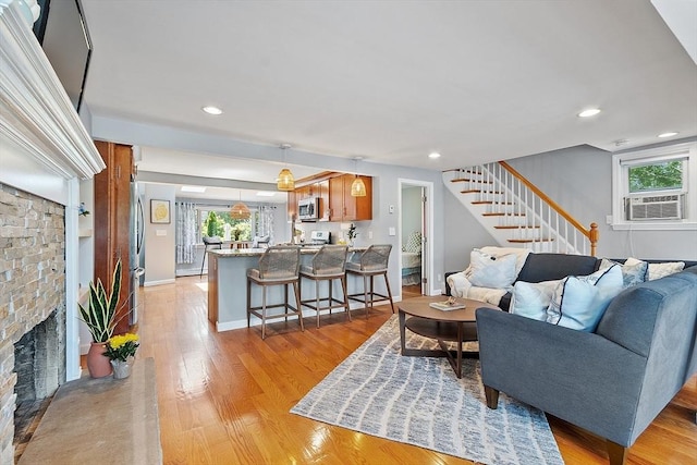 9 Crescent Ave, Lynnfield, MA 01940 - living room with cooling unit, stairway, light wood finished floors, a fireplace, and recessed lighting