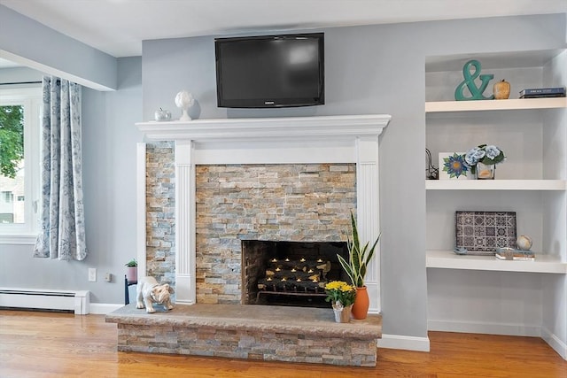 9 Crescent Ave, Lynnfield, MA 01940 - detailed view of a baseboard radiator, wood finished floors, and a fireplace