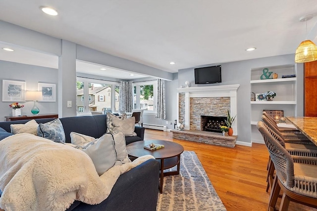 9 Crescent Ave, Lynnfield, MA 01940 - living room featuring baseboard heating, light wood-type flooring, a fireplace, and recessed lighting