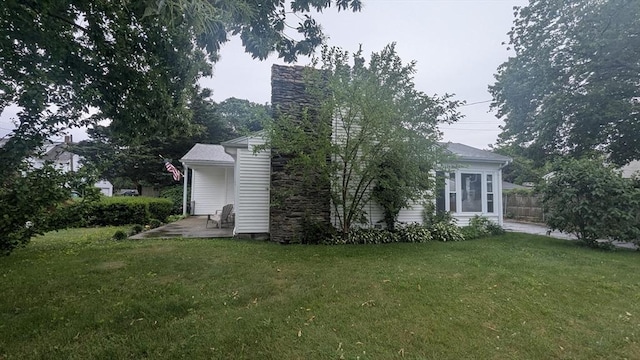 34 Coolidge St, Dartmouth, MA 02748 - view of side of home featuring a patio and a chimney