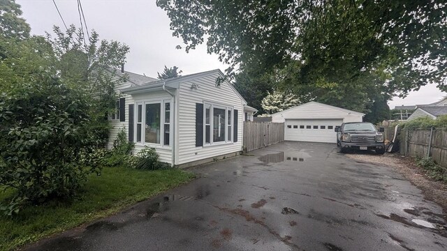 34 Coolidge St, Dartmouth, MA 02748 - view of side of home with a detached garage and an outdoor structure