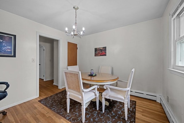 34 Coolidge St, Dartmouth, MA 02748 - dining space featuring wood finished floors, a chandelier, and baseboard heating