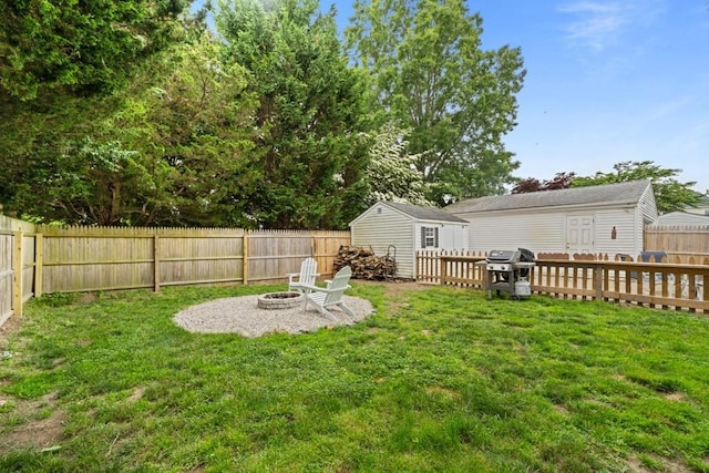 34 Coolidge St, Dartmouth, MA 02748 - fenced backyard with an outdoor fire pit and an outbuilding