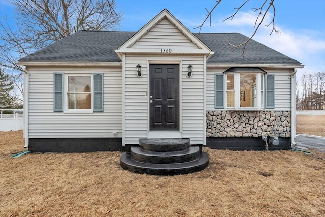 bungalow-style home with a front lawn