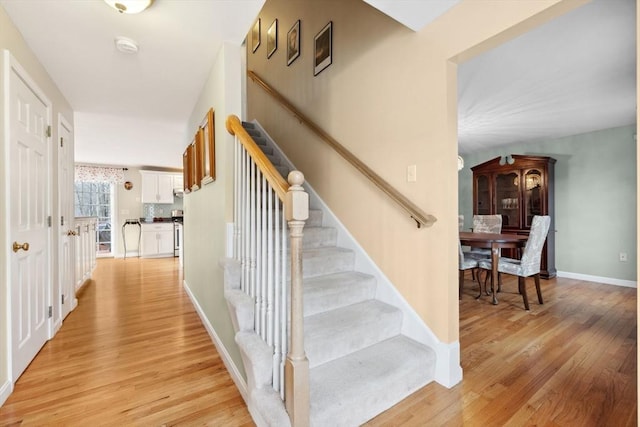 stairs with hardwood / wood-style floors