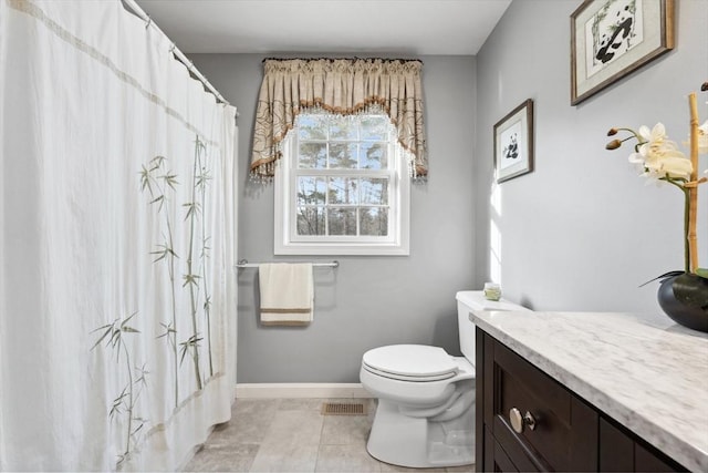 bathroom featuring toilet, tile patterned floors, and vanity