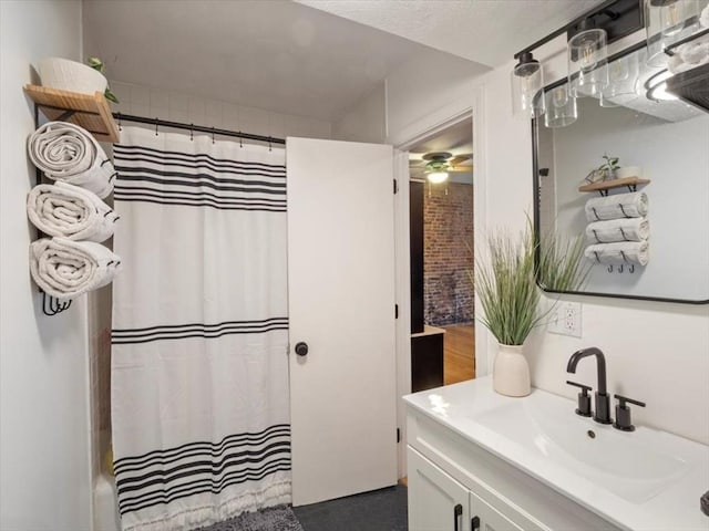 bathroom with curtained shower and vanity