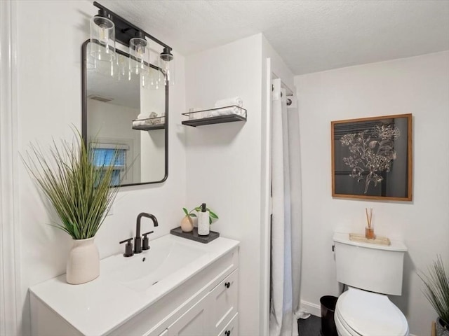 full bathroom with toilet, walk in shower, and vanity