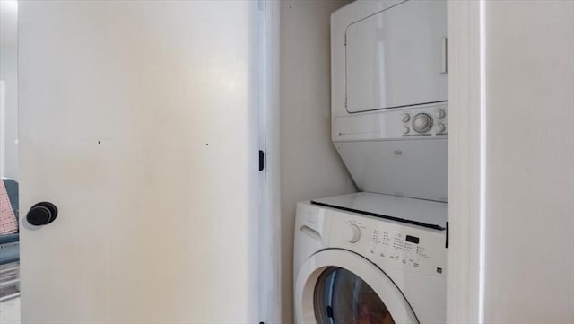 laundry area with stacked washer and dryer and laundry area