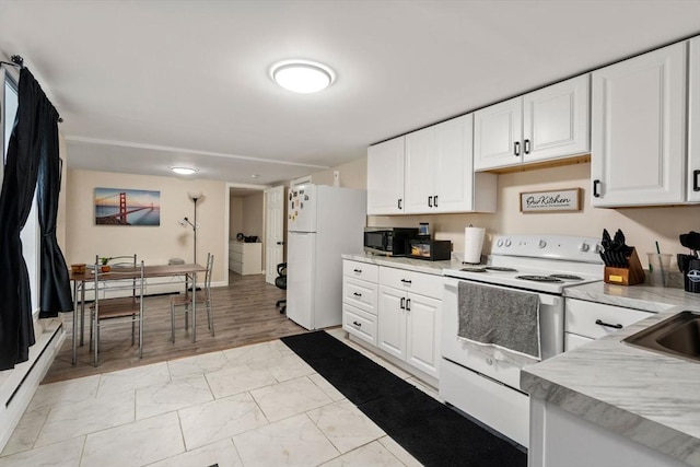 kitchen featuring white appliances, light countertops, marble finish floor, and white cabinets