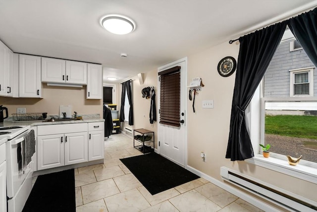 kitchen featuring light countertops, white cabinetry, a baseboard heating unit, and electric range