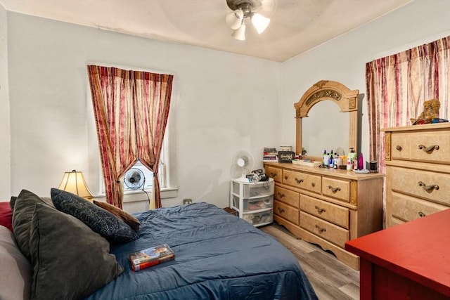 bedroom with light wood-style flooring and a ceiling fan