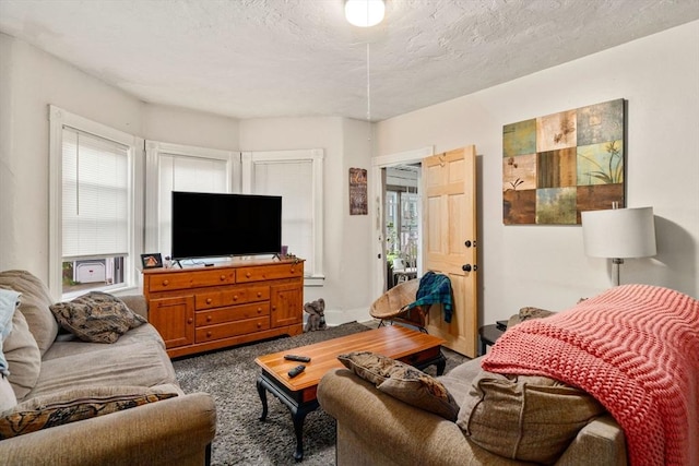 carpeted living room featuring a textured ceiling